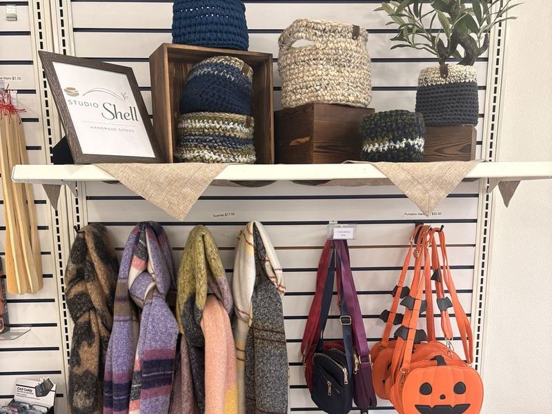Studio Shell hand-knitted baskets, with scarves and bags below